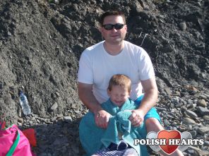 On the beach, sun in sons eyes poor chap lol